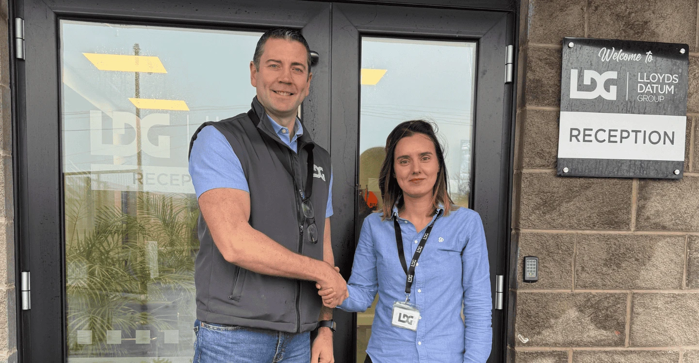 Miriam Temino and Mark Hodgen shaking hands outside of LDG Office
