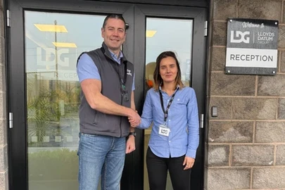 Miriam Temino and Mark Hodgen shaking hands outside of LDG Office